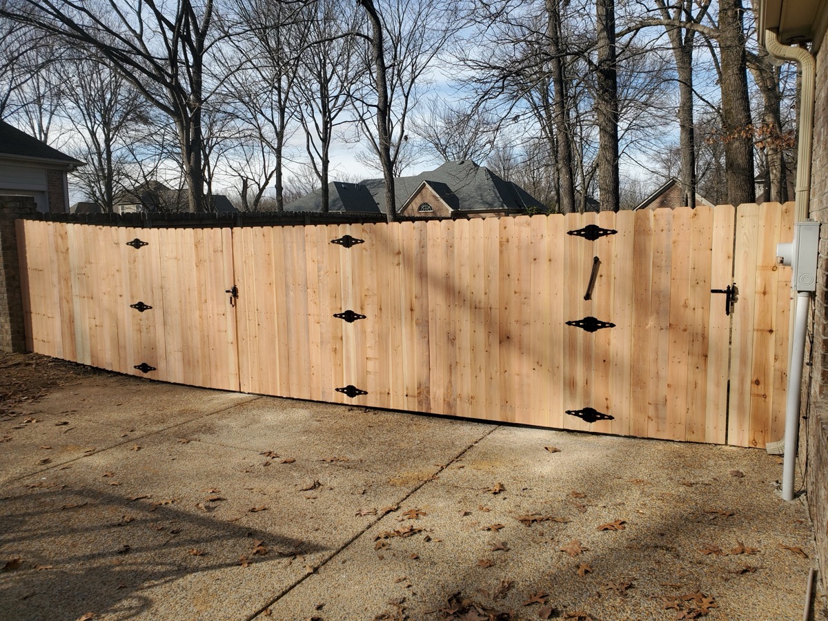 Multi-gate cedar driveway installation with decorative black iron hardware