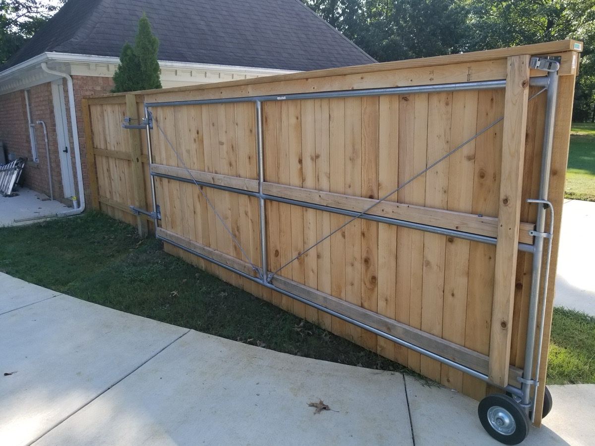 Wide rolling gate back view showing metal frame and roller construction