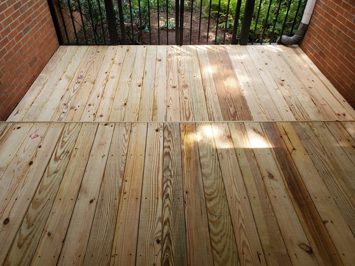 Fresh wood porch deck resurfacing with new boards