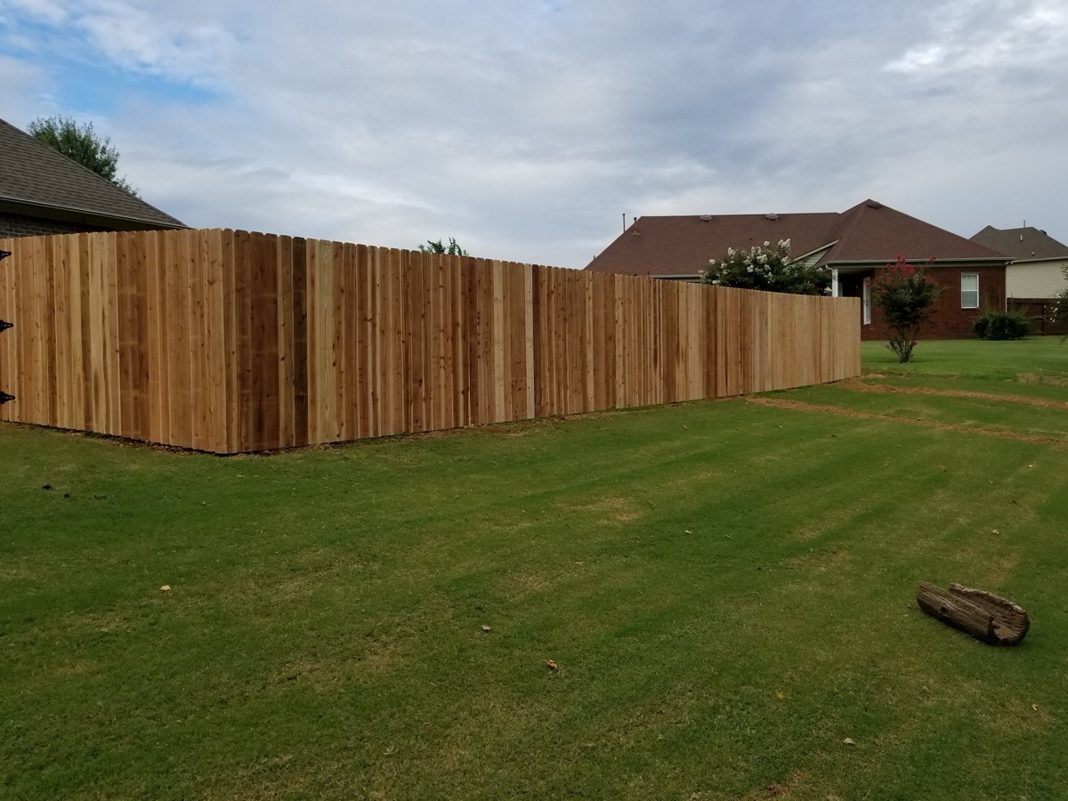 Privacy fence along green lawn in residential neighborhood