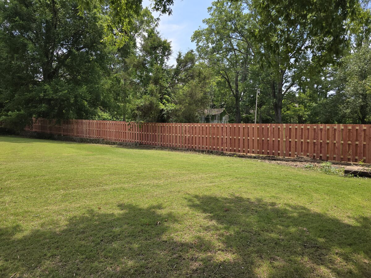 Long run of shadowbox fence across sunny backyard
