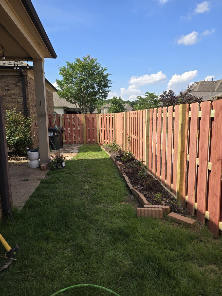 Cedar shadowbox fence with new garden beds in side yard