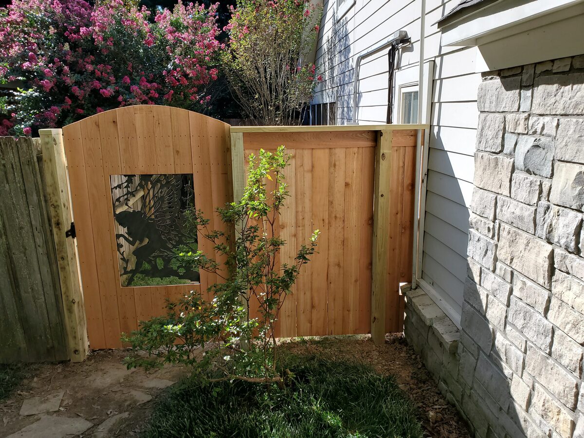 Arched western cedar walk gate with decorative iron insert