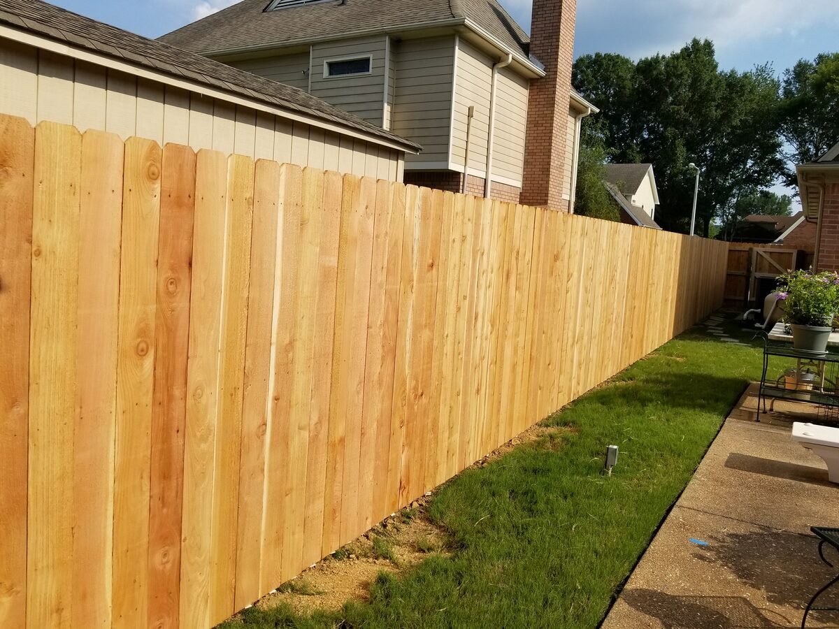 Close-up of western cedar fence pickets along side of house
