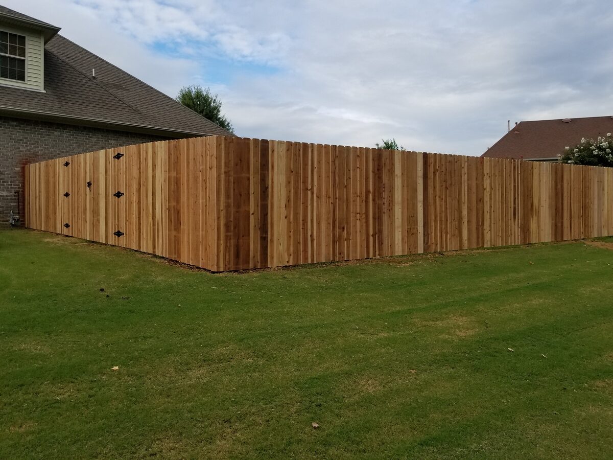 Western cedar fence corner with black gate hardware