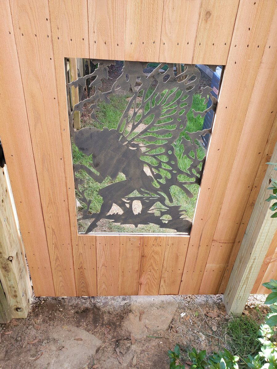 Decorative iron insert panel detail in western cedar gate