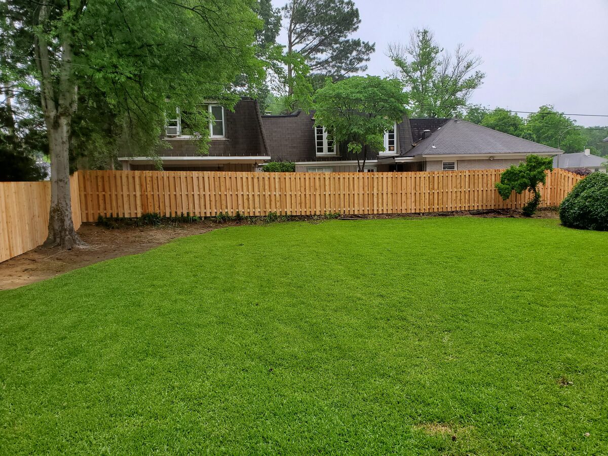Shadowbox-style fence built in western cedar across backyard