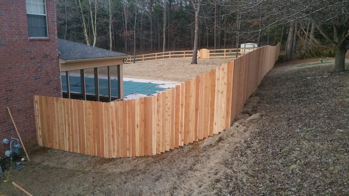Western cedar fence stepping down slope to pool area