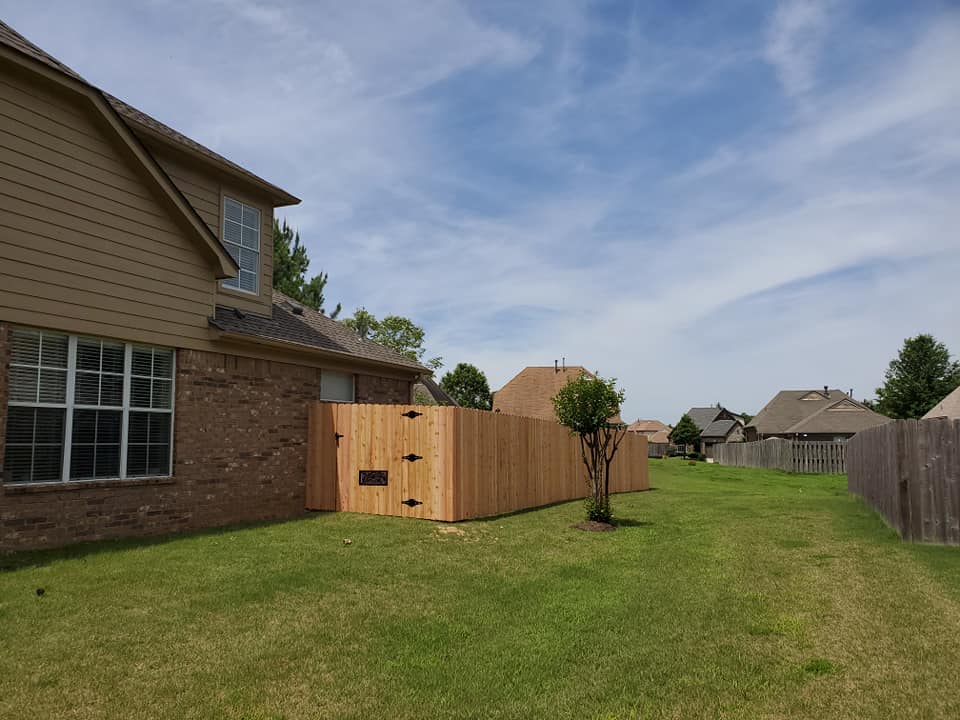 Wood privacy fence with gate in residential neighborhood